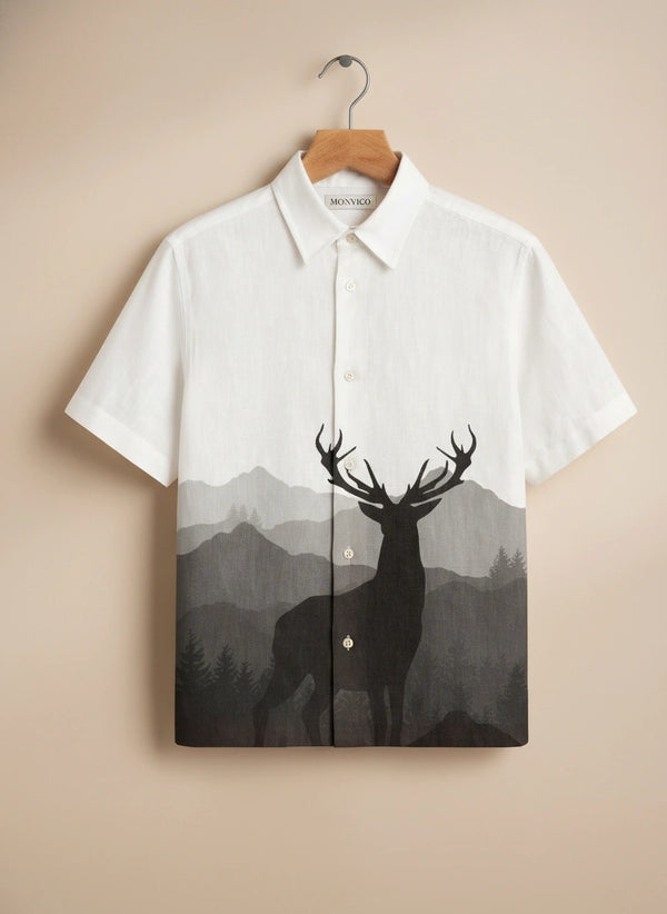 White shirt with deer and mountain design on a beige background