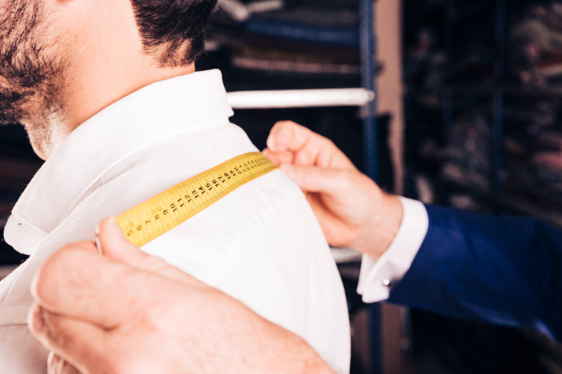 A Guy is Measure a Shirt Size
