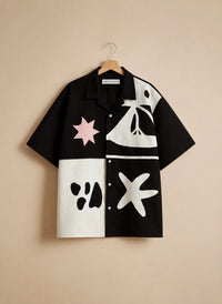 Black and white shirt with abstract designs on a beige background