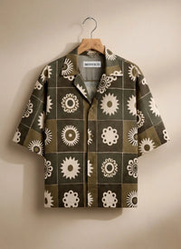 Patterned shirt on a hanger against a neutral background