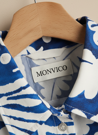 Blue and white patterned shirt on a hanger with Brand Label.