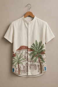 Short-sleeve shirt with architectural and palm tree design on a beige background