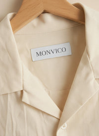 Beige shirt with a Monvico label on a wooden hanger